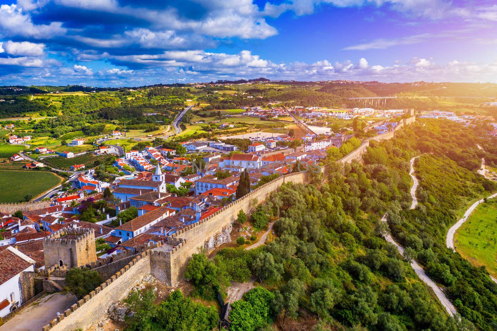 Aerial view of the historic walled town of Obidos at sunset, near Lisbon, Portugal. Aerial shot of Obidos Medieval Town, Portugal. Aerial view of medieval fortress in Obidos. Portugal.
