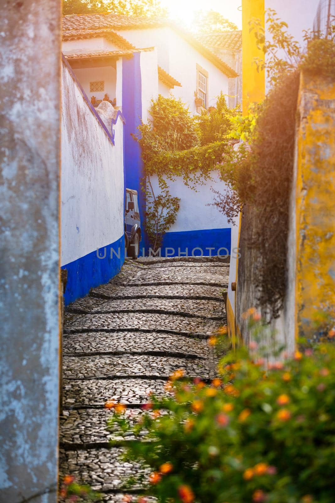 Historic walled town of Obidos, near Lisbon, Portugal. Beautiful streets of Obidos Medieval Town, Portugal. Street view of medieval fortress in Obidos. Portugal.