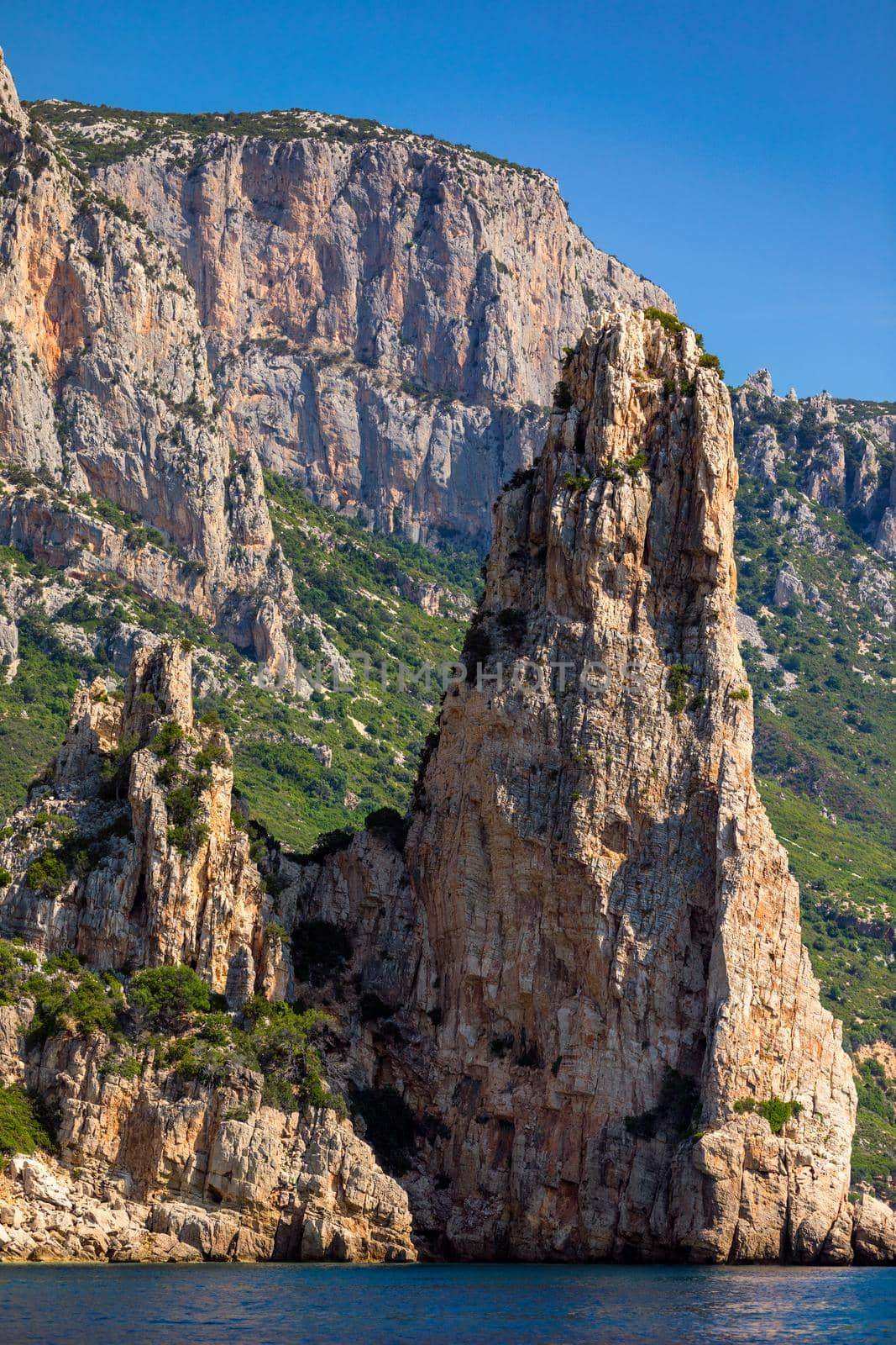 The monolith of Pedra Longa, Baunei, province of Ogliastra, East Sardinia, Italy. The rocky spire which rises majestically out of the sea. Holidays in Sardinia, Italy.