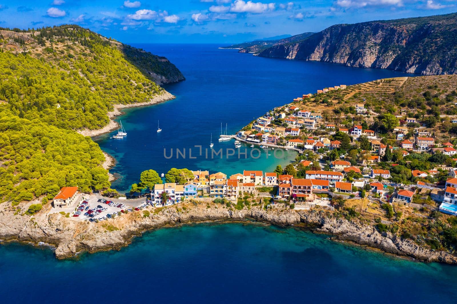 Aerial drone view video of beautiful and picturesque colorful traditional fishing village of Assos in island of Cefalonia, Ionian, Greece. Peninsula of Assos in Cephalonia (Kefalonia), Greece
