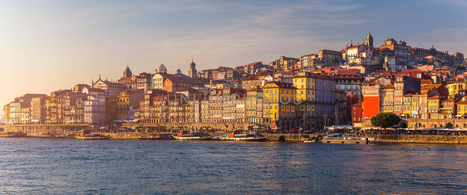 Colorful houses of Porto Ribeira, traditional facades, old multi-colored houses with red roof tiles on the embankment in the city of Porto, Portugal
