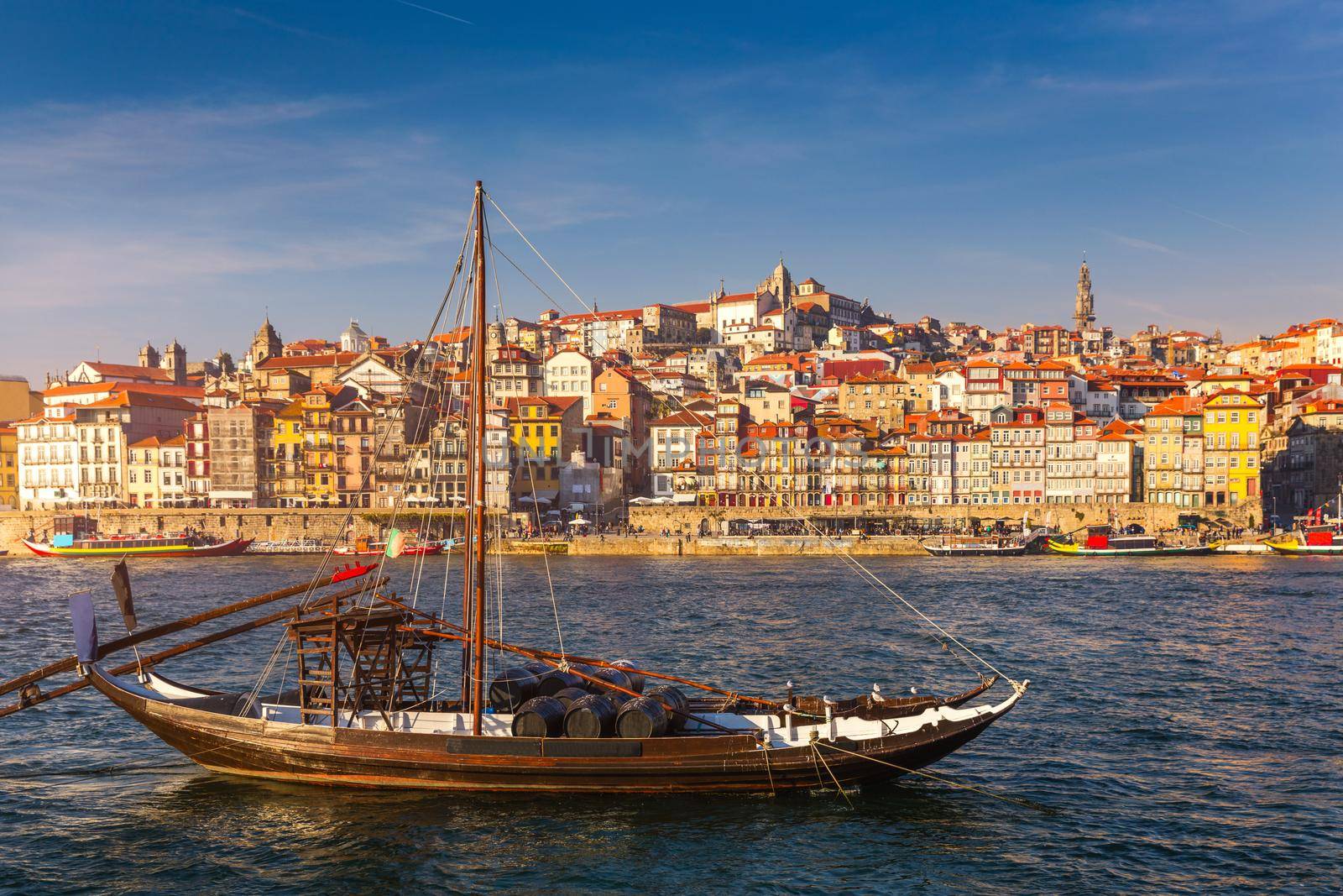 Port wine boats at the waterfront with the old town on the Douro River in Ribeira in the city centre of Porto in Porugal, Europe. Portugal, Porto