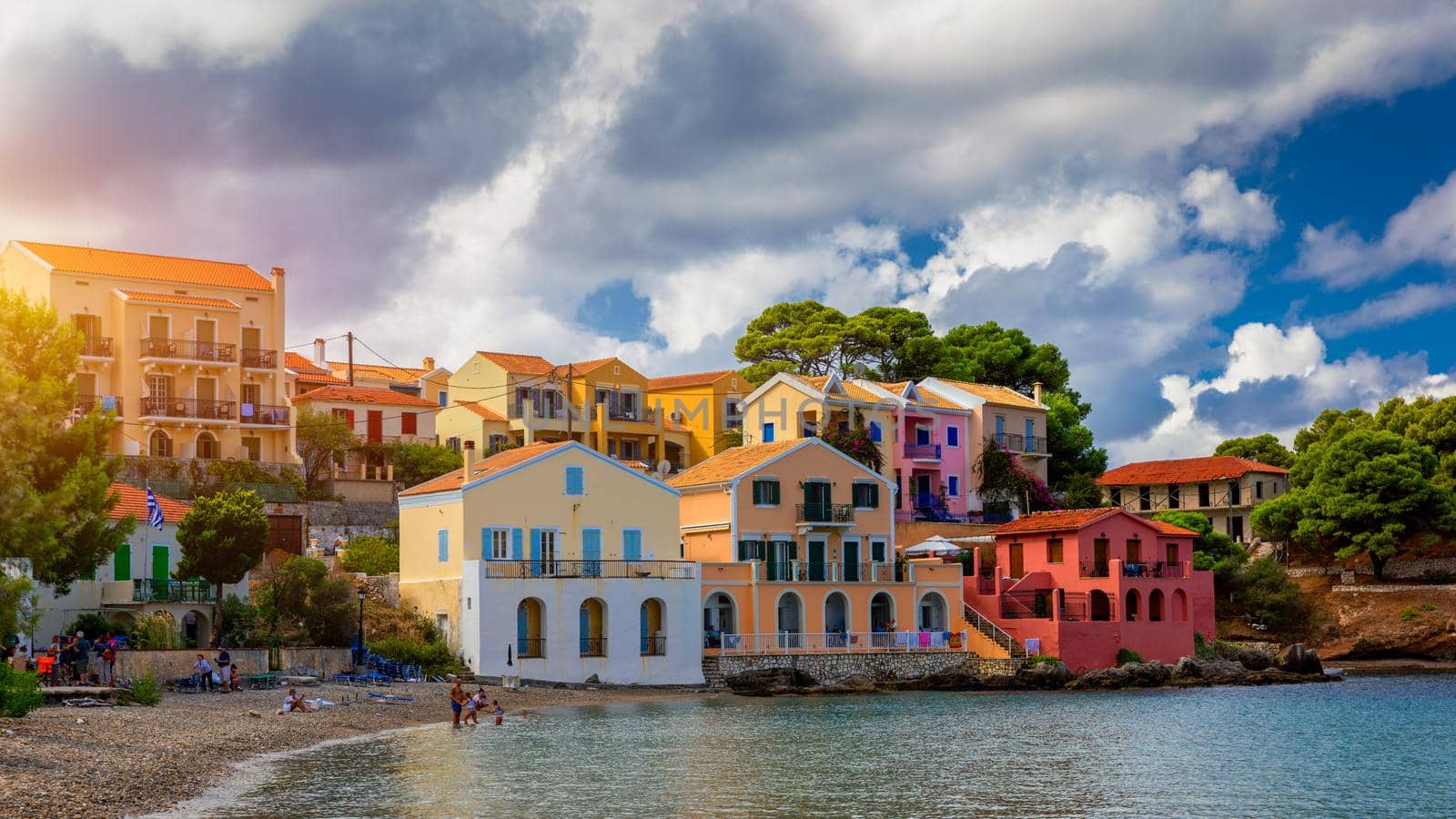 Assos village in Kefalonia, Greece. Turquoise colored bay in Mediterranean sea with beautiful colorful houses in Assos village in Kefalonia, Greece, Ionian island, Cephalonia, Assos village.
