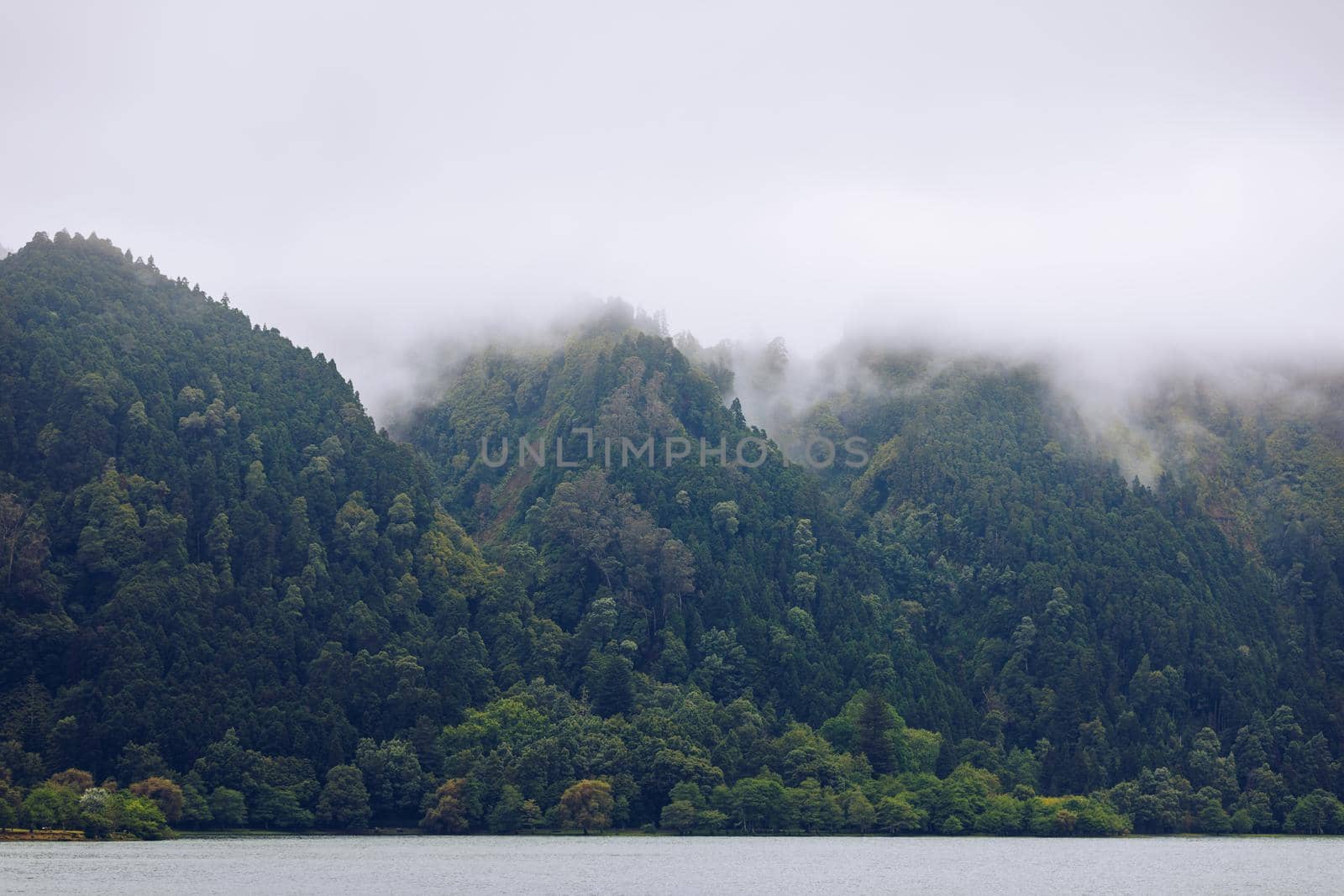 Azores panoramic view of natural landscape, wonderful scenic island of Portugal. Beautiful lagoons in volcanic craters and green fields. Tourist attraction and travel destination. Azores, Portugal.