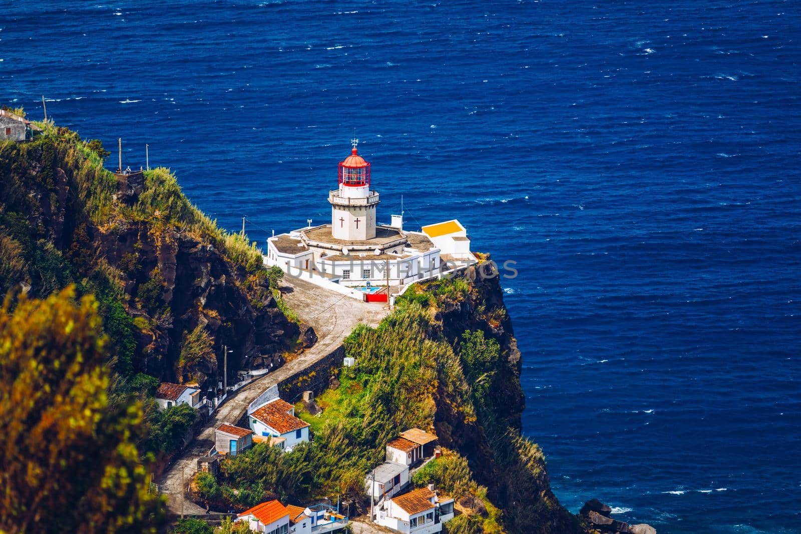 Dramatic view down to lighthouse on Ponta do Arnel, Nordeste, Sao Miguel Island, Azores, Portugal. Lighthouse Arnel near Nordeste on Sao Miguel Island, Azores, Portugal. 