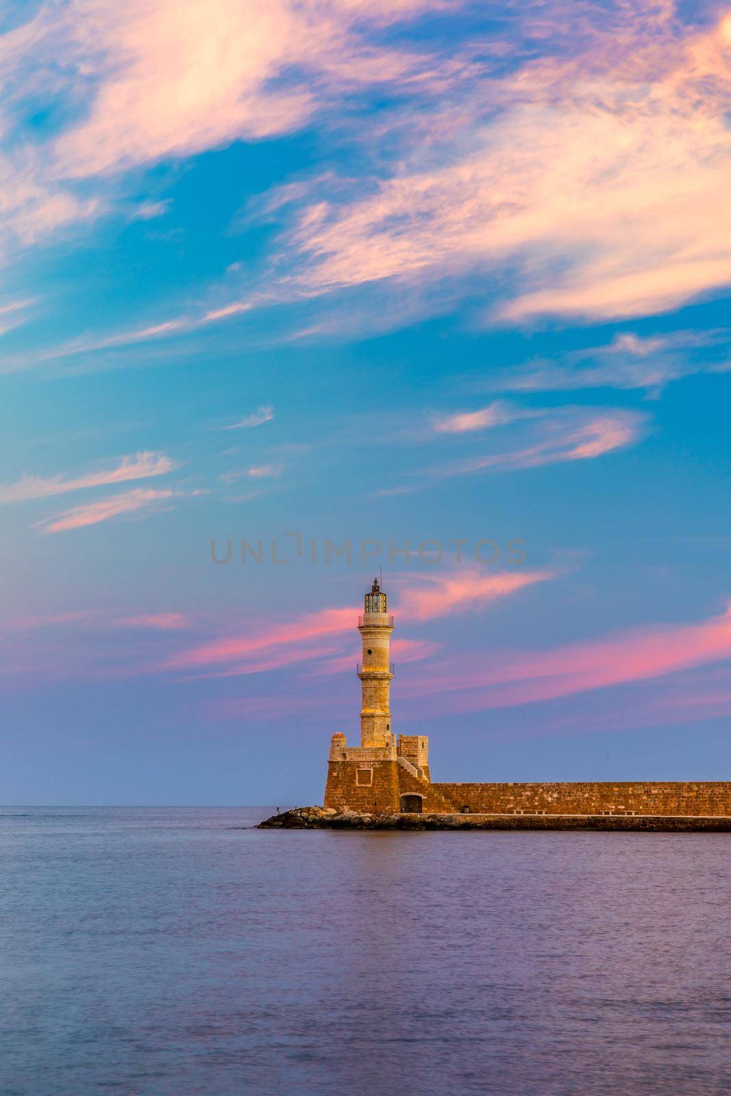 Venetian harbour and lighthouse in old harbour of Chania at sunrise, Crete, Greece. Old venetian lighthouse in Chania, Greece. Lighthouse of the old Venetian port in Chania, Greece.