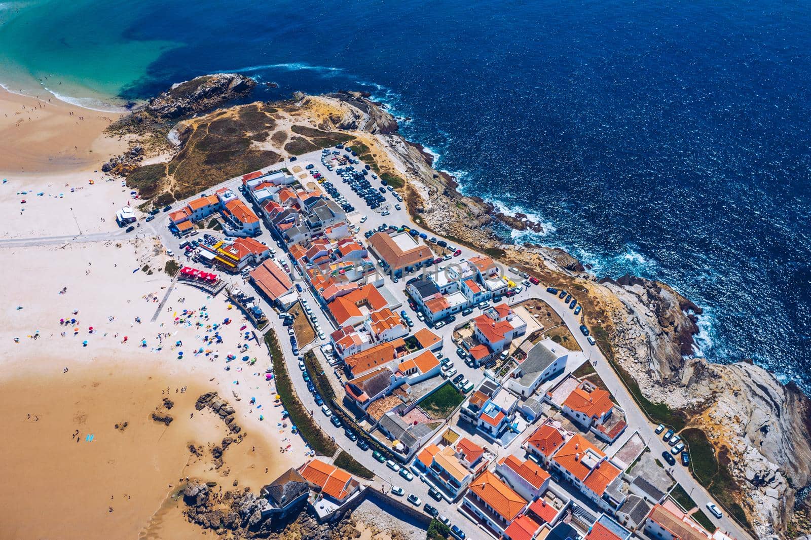 Aerial view of island Baleal naer Peniche on the shore of the ocean in west coast of Portugal. Baleal Portugal with incredible beach and surfers. Aerial view of Baleal, Portugal.