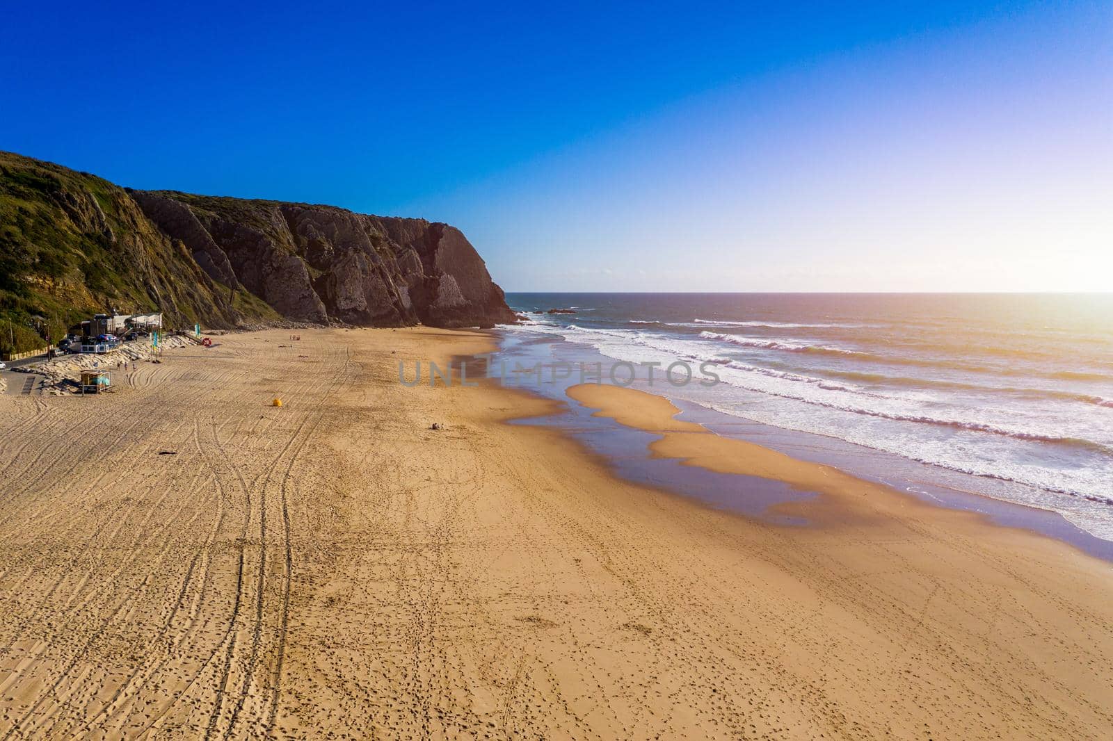 Praia Grande, Portugal. Beautiful sunset in the portuguese beach Praia Grande, in Portugal. Beach of Praia Grande. View of Atlantic beach and big waves. Colares, Sintra, Portugal. 