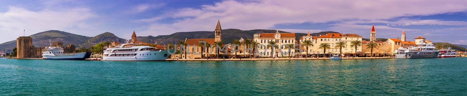 Historic buildings on promenade in Trogir, Croatia. Trogir is popular travel destination in Croatia. Trogir, as a UNESCO World Heritage Site, is one of most visited places in Dalmatia, Croatia.