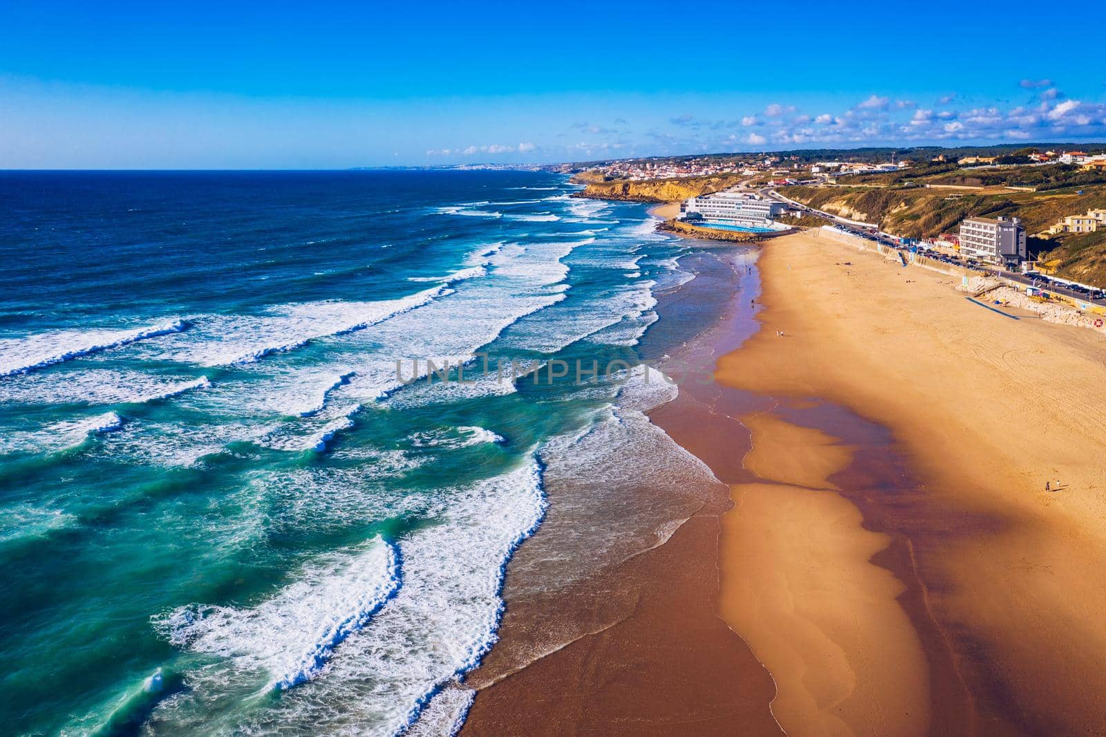 Praia Grande, Portugal. Beautiful sunset in the portuguese beach Praia Grande, in Portugal. Beach of Praia Grande. View of Atlantic beach and big waves. Colares, Sintra, Portugal. 