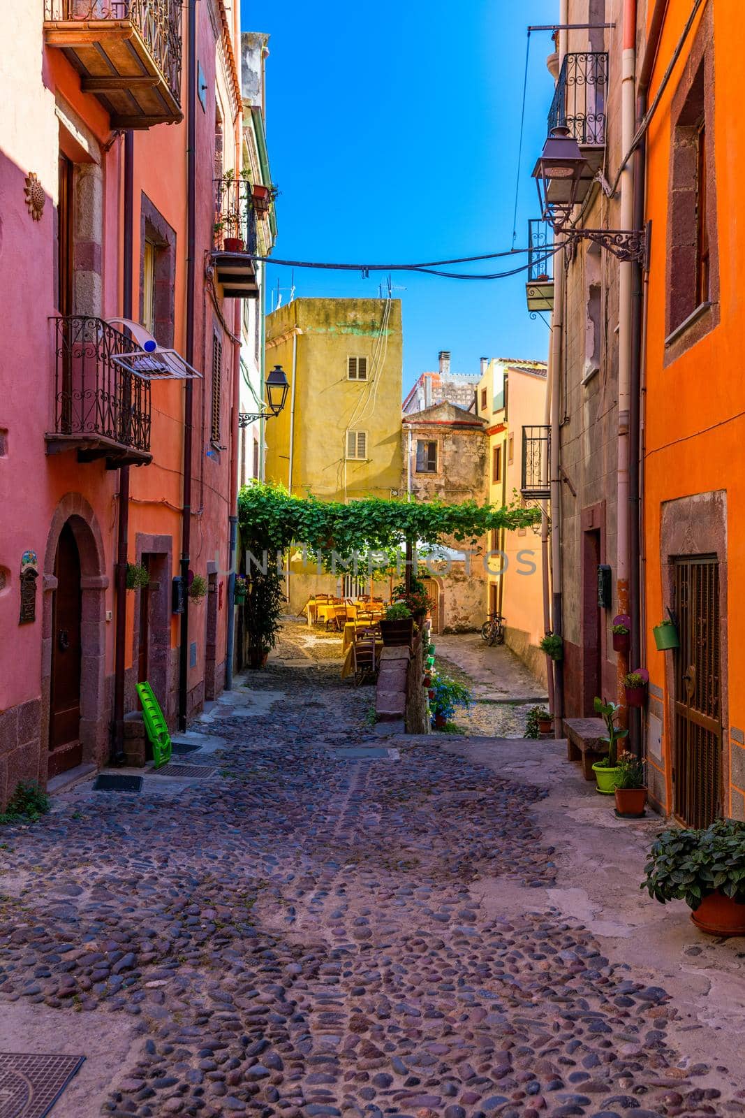 Street view of the beautiful village of Bosa with colored houses and a medieval castle. Bosa is located in the north-wesh of Sardinia, Italy. Street view of colorful houses in Bosa village, Sardegna.
