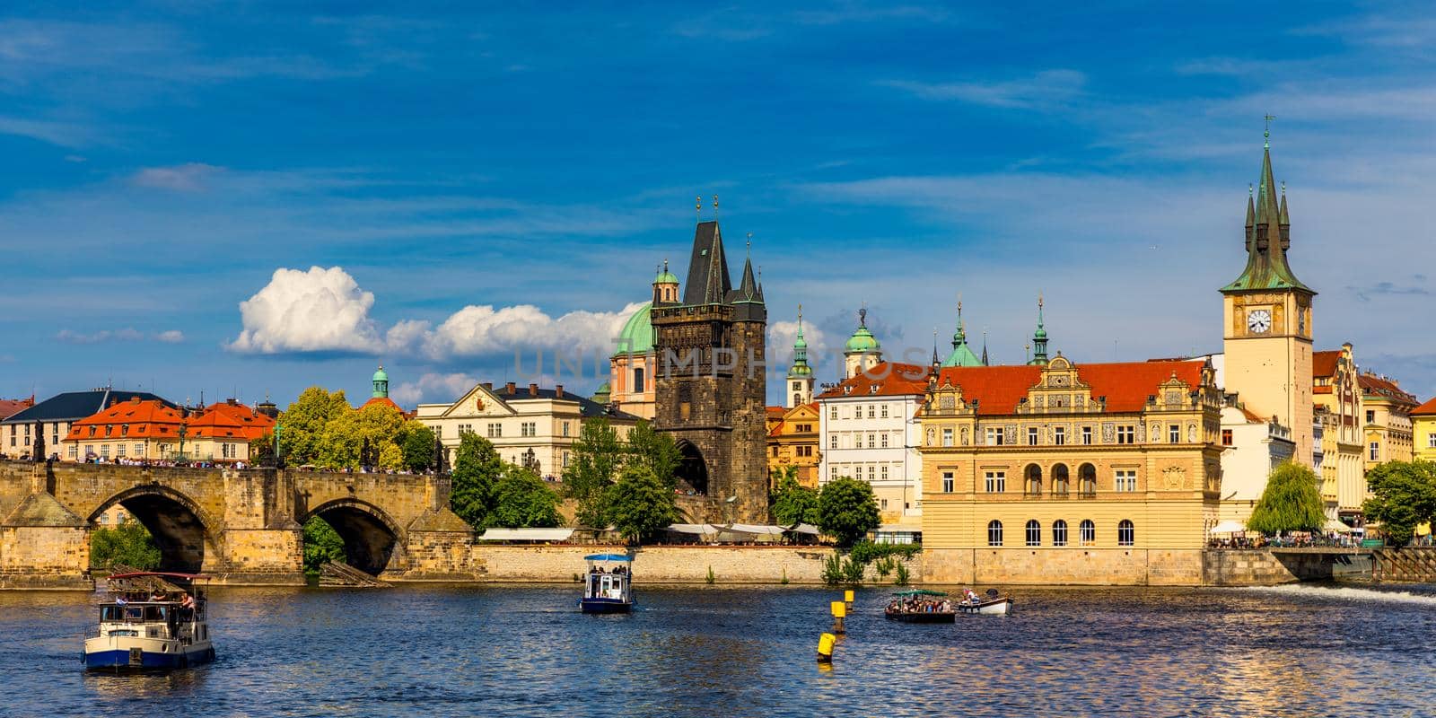 Prague in a sunny day, view of the old town, Prague, Czech Republic. Scenic summer view of the Old Town pier architecture and Charles Bridge over Vltava river in Prague, Czech Republic