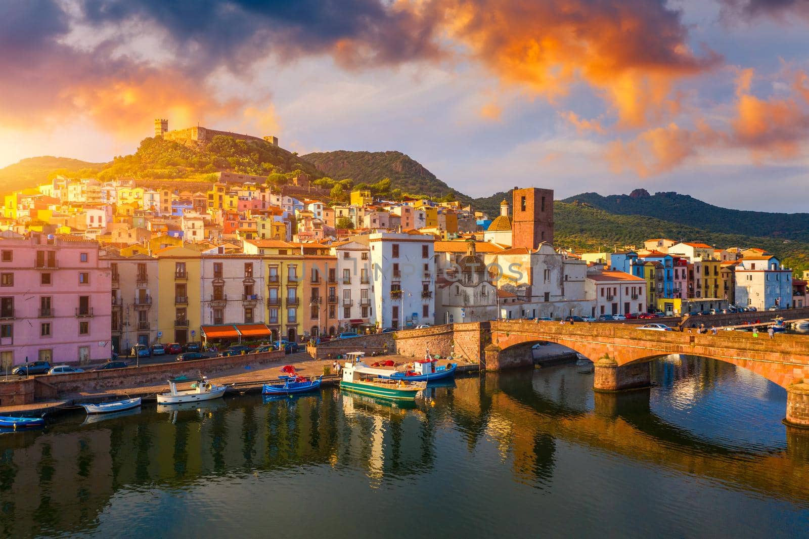 Aerial view of the beautiful village of Bosa with colored houses and a medieval castle. Bosa is located in the north-wesh of Sardinia, Italy. Aerial view of colorful houses in Bosa village, Sardegna.