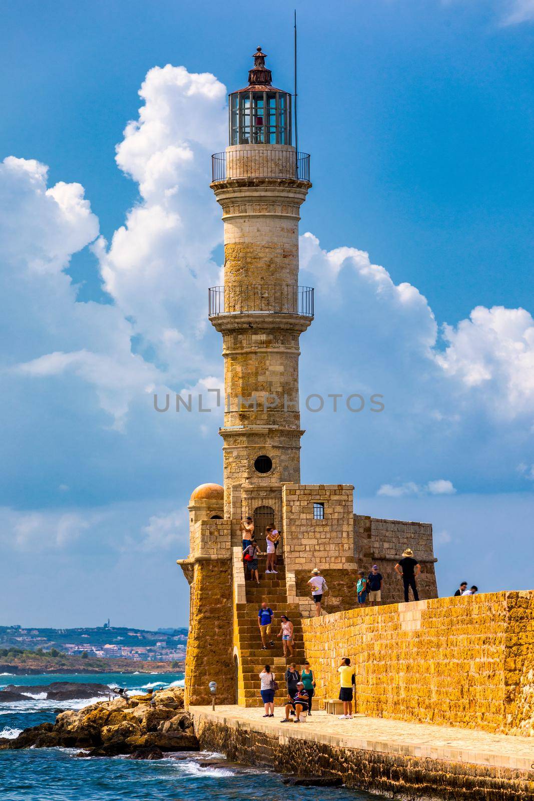 Panorama of venetian harbour waterfront and lighthouse in old harbour of Chania, Crete, Greece. Old venetian lighthouse in Chania, Greece. Lighthouse of the old Venetian port in Chania, Greece.