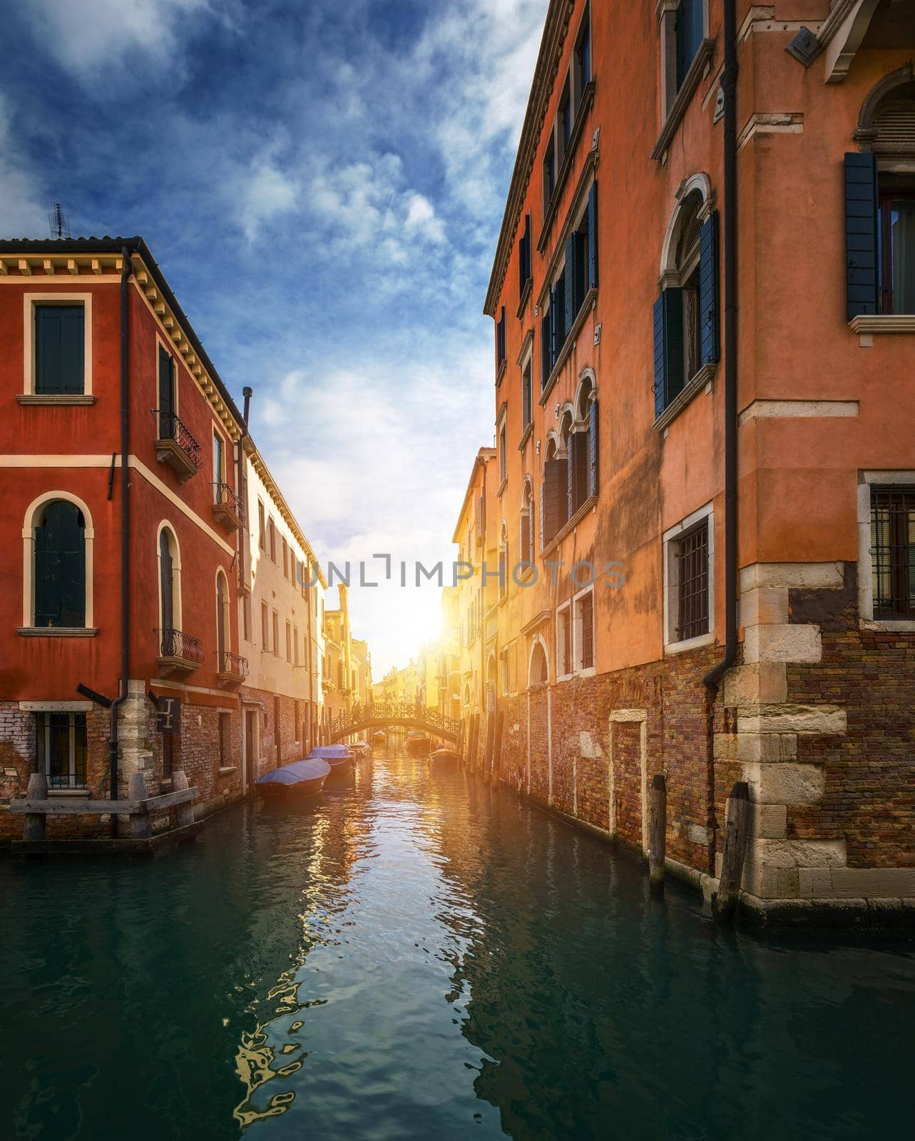 View of the street canal in Venice, Italy. Colorful facades of old Venice houses. Venice is a popular tourist destination of Europe. Venice, Italy.