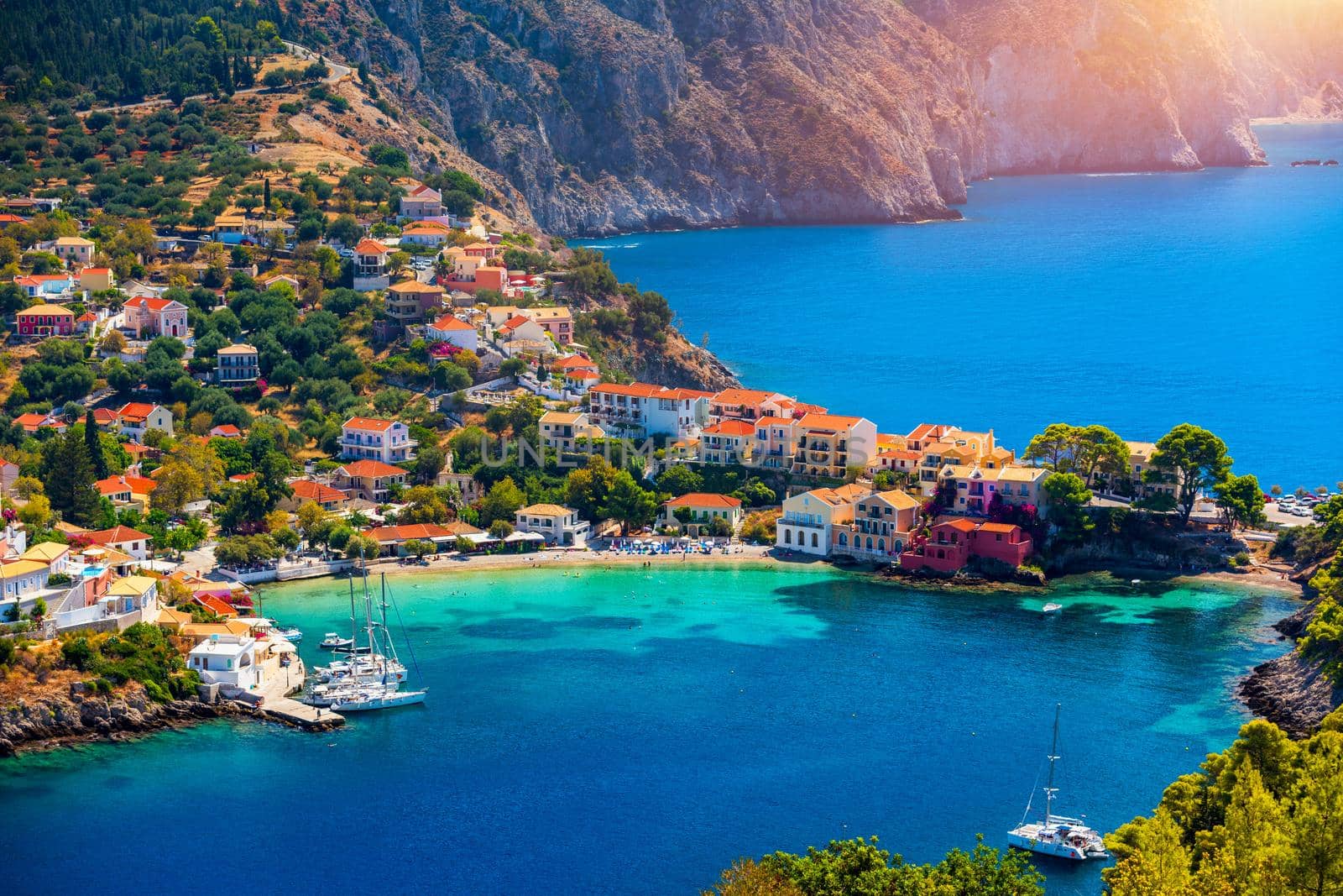 Assos village in Kefalonia, Greece. Turquoise colored bay in Mediterranean sea with beautiful colorful houses in Assos village in Kefalonia, Greece, Ionian island, Cephalonia, Assos village.