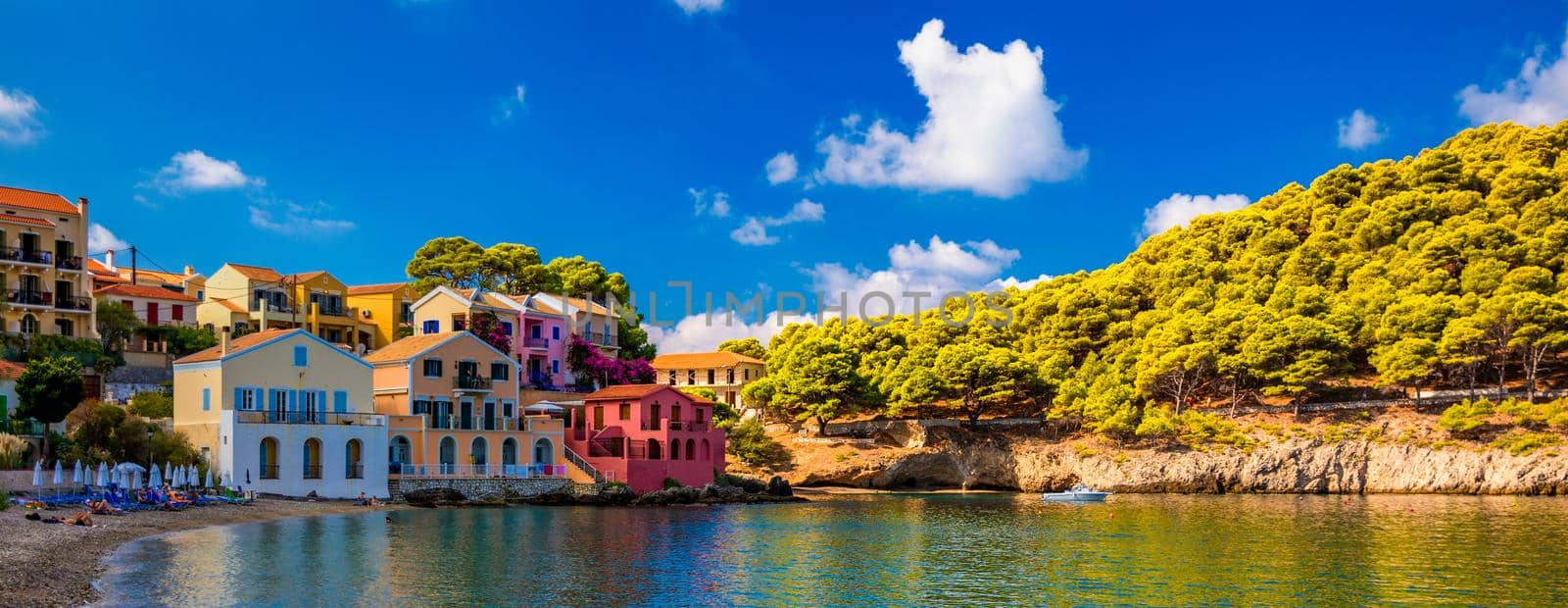 Assos village in Kefalonia, Greece. Turquoise colored bay in Mediterranean sea with beautiful colorful houses in Assos village in Kefalonia, Greece, Ionian island, Cephalonia, Assos village.