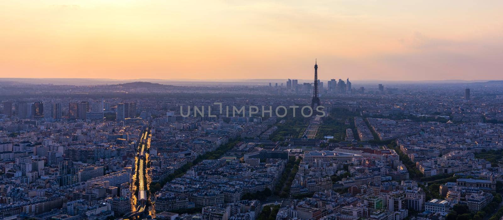 Panoramic aerial view of Paris, Eiffel Tower and La Defense business district. Aerial view of Paris at sunset. Panoramic view of Paris skyline with Eiffel Tower and La Defense. Paris, France. 