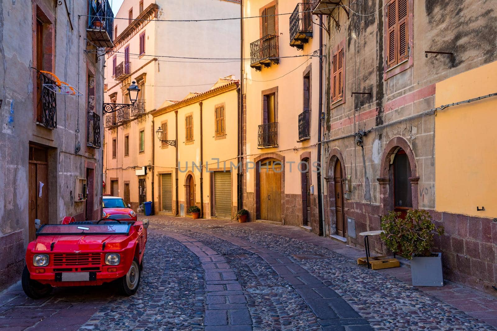Street view of the beautiful village of Bosa with colored houses and a medieval castle. Bosa is located in the north-wesh of Sardinia, Italy. Street view of colorful houses in Bosa village, Sardegna.