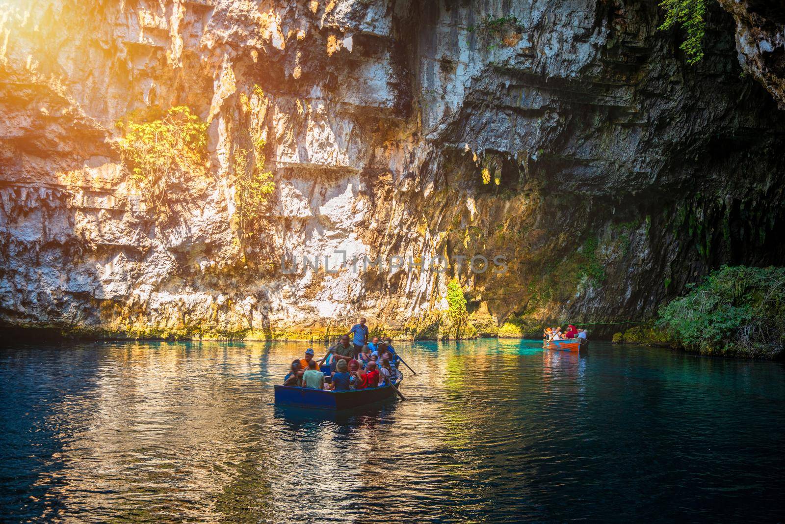Melissani lake on Kefalonia island, Greece. Melissani Cave (Melissani Lake) near Sami village in Kefalonia island, Greece. Tourist boat on the lake in Melissani Cave, Kefalonia Island, Greece