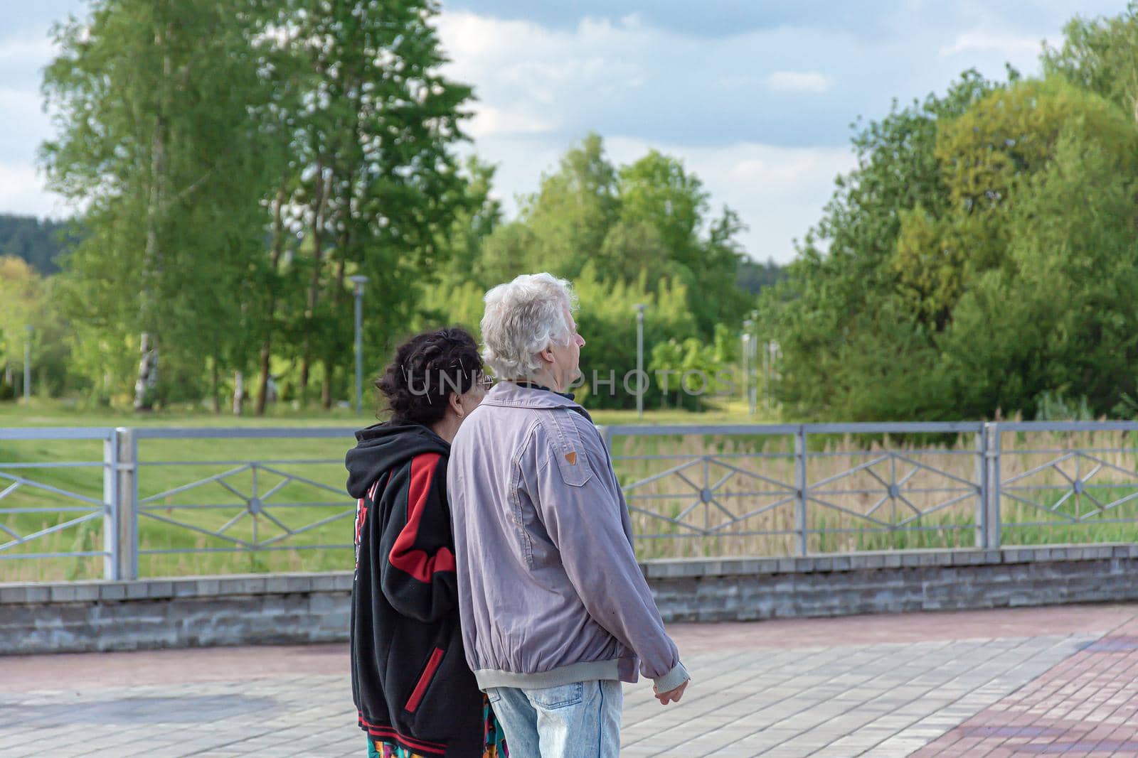 man and a woman at the age for a walk in the park. Close-up, blurred background. Stock photography.