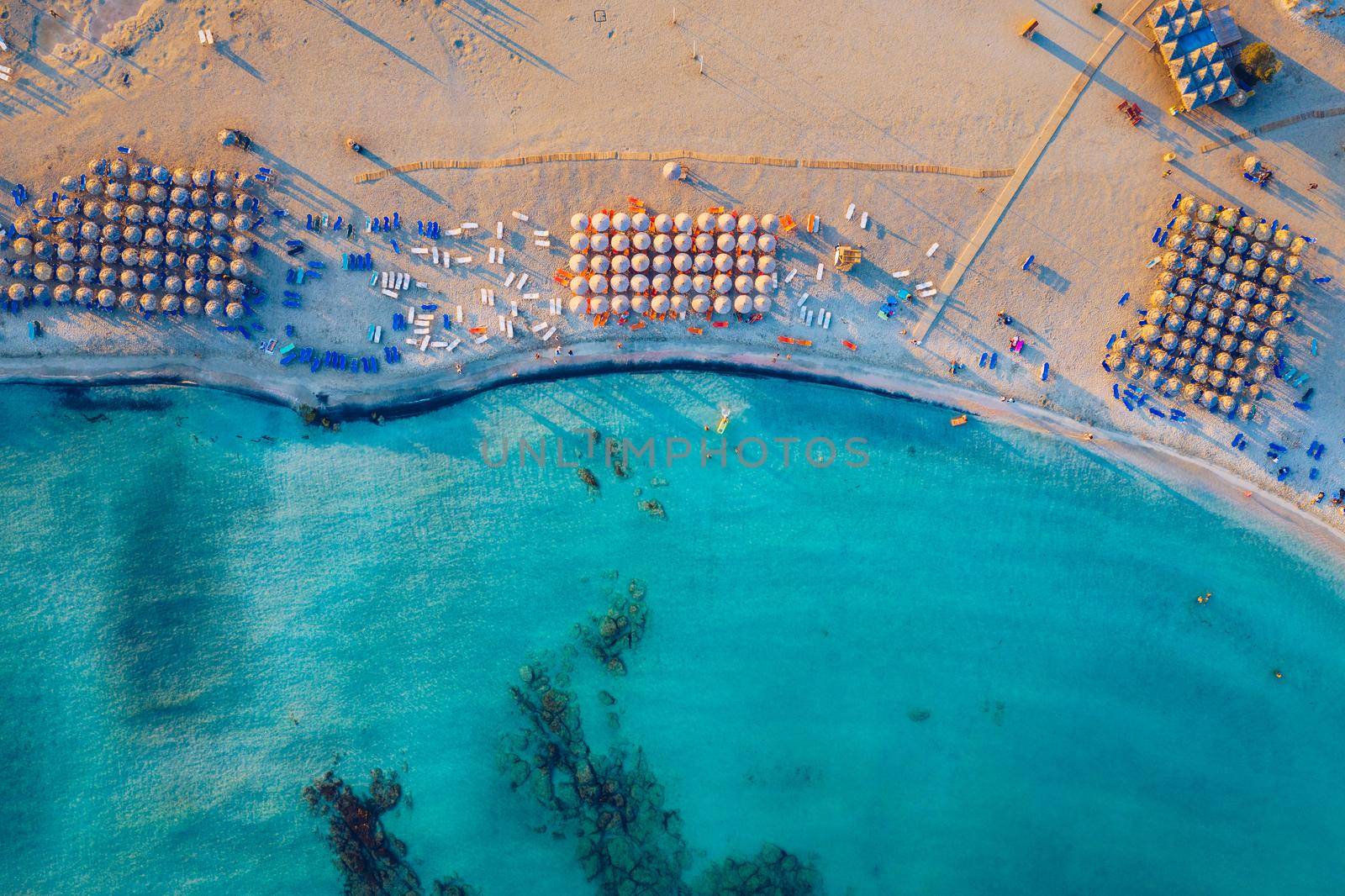 Aerial view of beautiful tropical Elafonissi Beach with pink sand. View of a nice tropical Elafonissi beach from the air. Beautiful sky, sea, resort. Elafonissi beach, Crete, Greece.