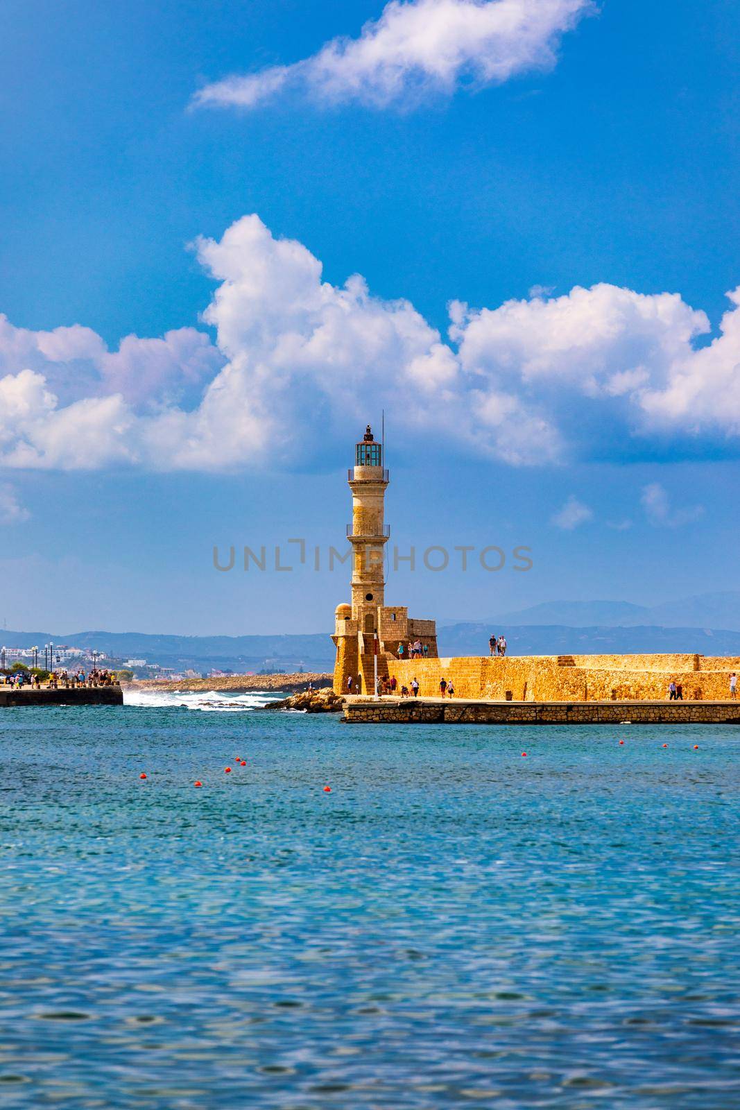 Panorama of venetian harbour waterfront and lighthouse in old harbour of Chania, Crete, Greece. Old venetian lighthouse in Chania, Greece. Lighthouse of the old Venetian port in Chania, Greece.