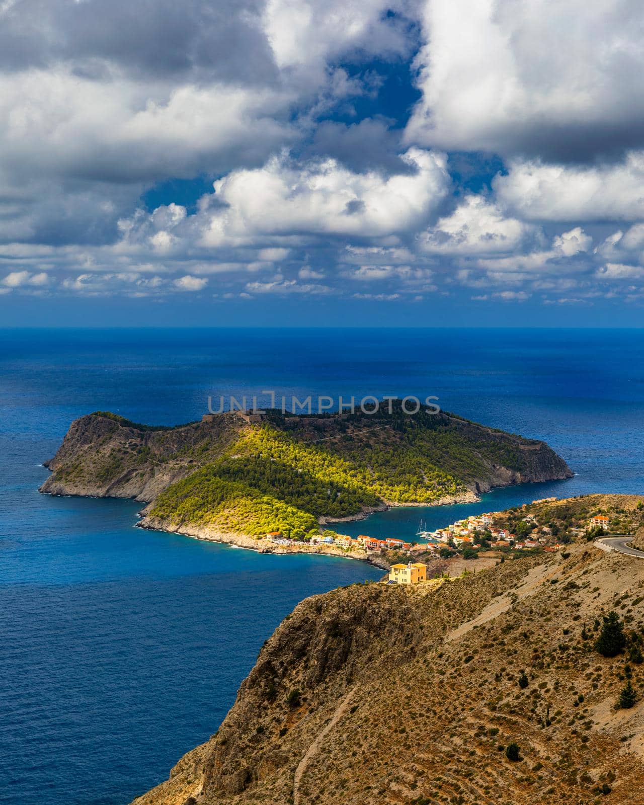 Assos village in Kefalonia, Greece. Turquoise colored bay in Mediterranean sea with beautiful colorful houses in Assos village in Kefalonia, Greece, Ionian island, Cephalonia, Assos village.