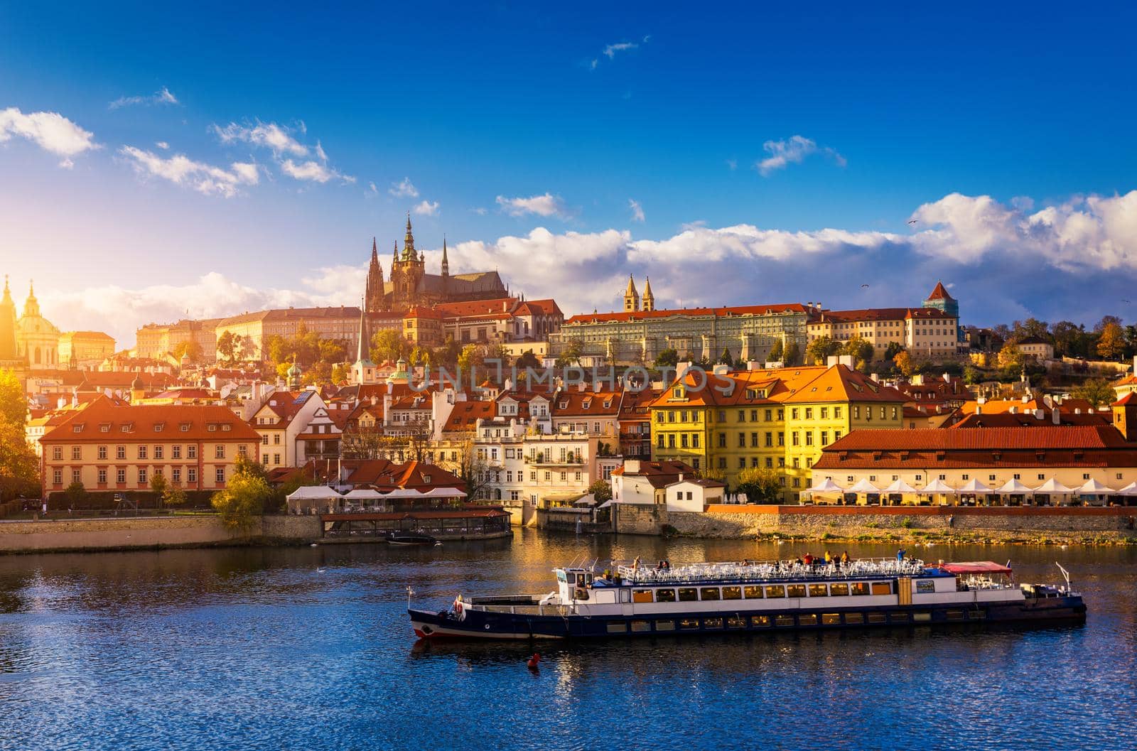Prague Castle, Charles Bridge and boats on the Vltava river. View of Hradcany Prague Castle, Charles Bridge and a boats on the Vltava river in the capital of the Czechia. Boat cruise on Vltava river.