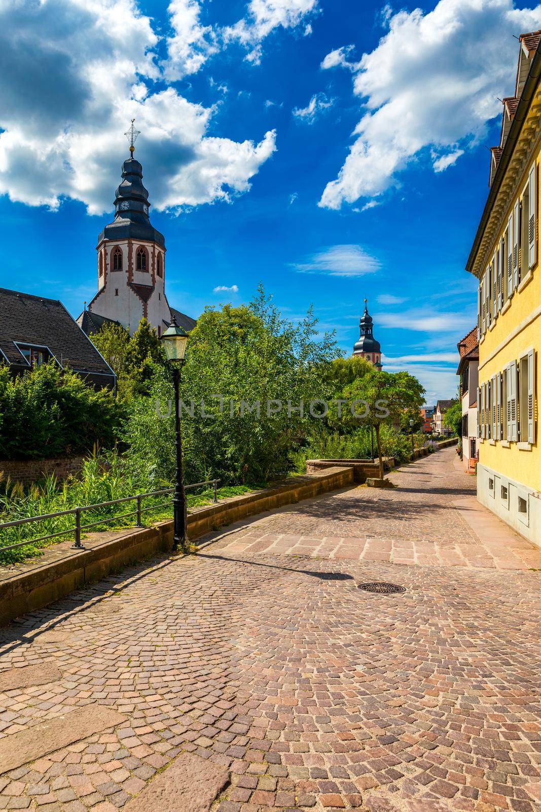 Old city of Ettlingen in Germany with a river and a church. View of a central district of Ettlingen, Germany, with a river and a bell tower of a church. Ettlingen, Baden Wurttemberg, Germany.