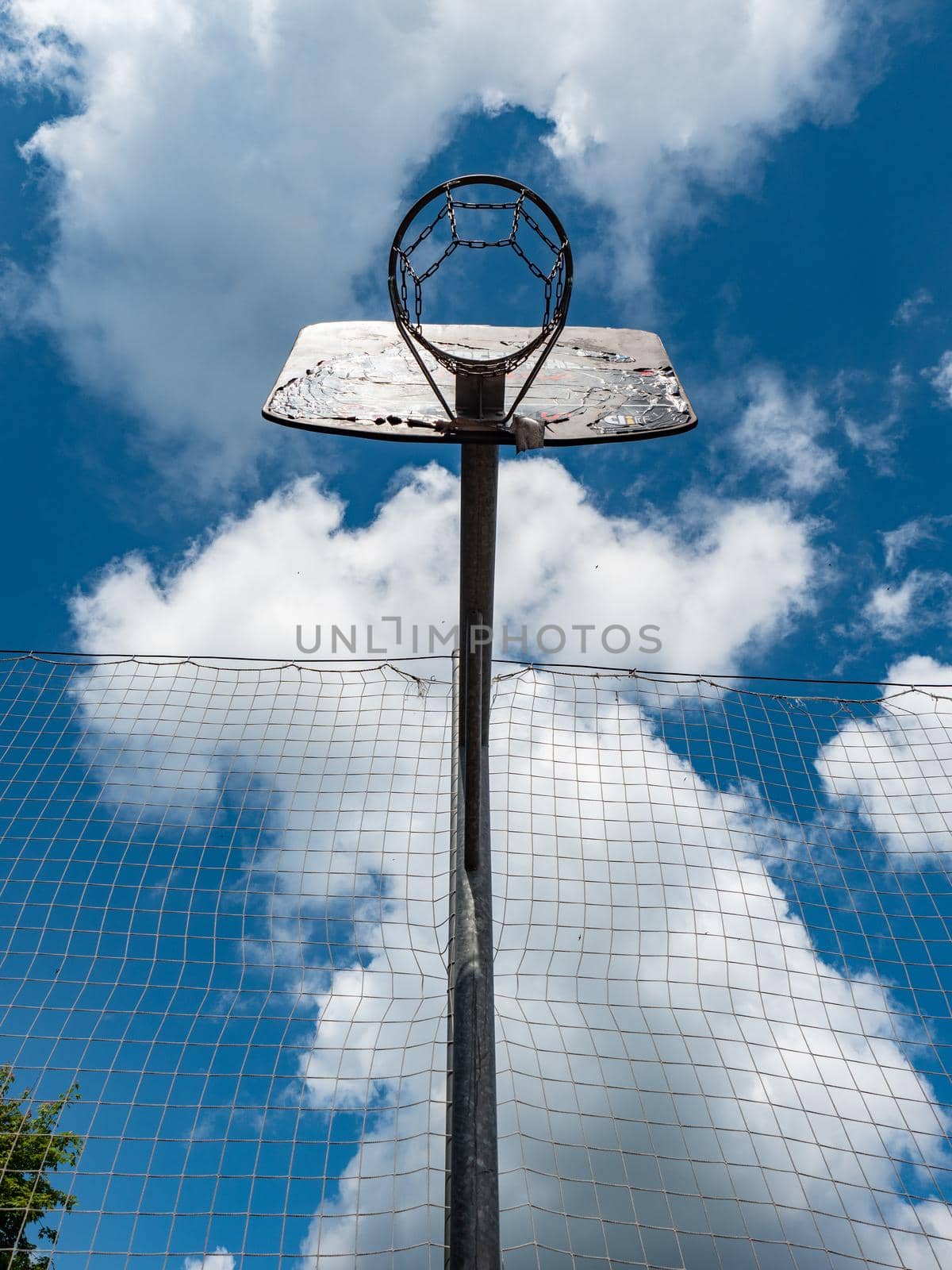 Basketball and a basket in an outdoor court with natural lightning. by rdonar2