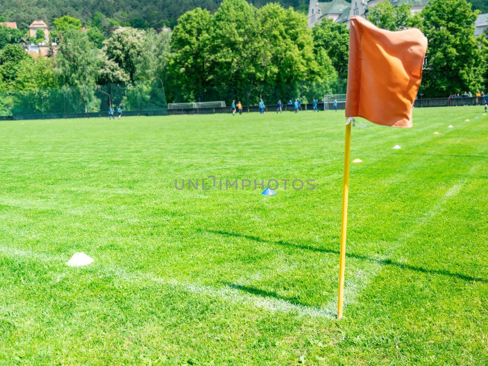 Red corner flag on soccer field at sunny day by rdonar2