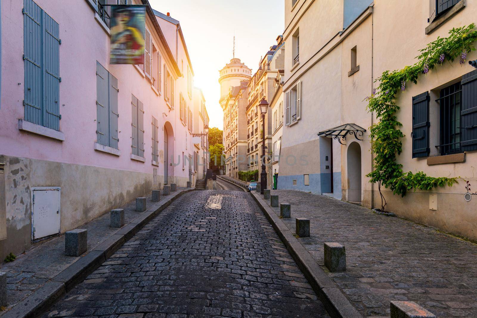 Montmartre district of Paris. Houses on narrow road in Montmartre district of Paris. View of cozy street in quarter Montmartre in Paris, France. Architecture and landmarks of Paris. Postcard of Paris.