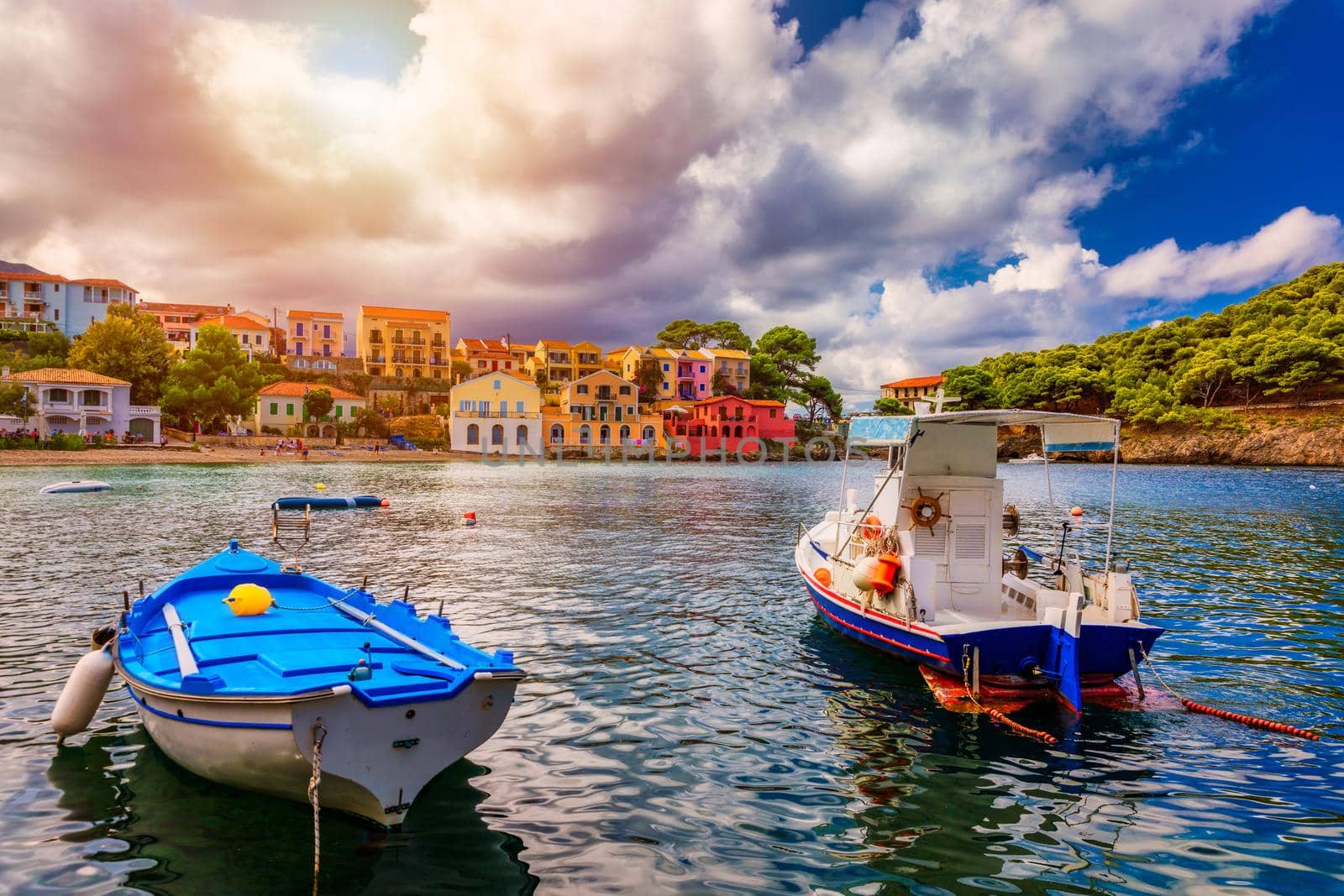 Assos village in Kefalonia, Greece. Turquoise colored bay in Mediterranean sea with beautiful colorful houses in Assos village in Kefalonia, Greece, Ionian island, Cephalonia, Assos village.