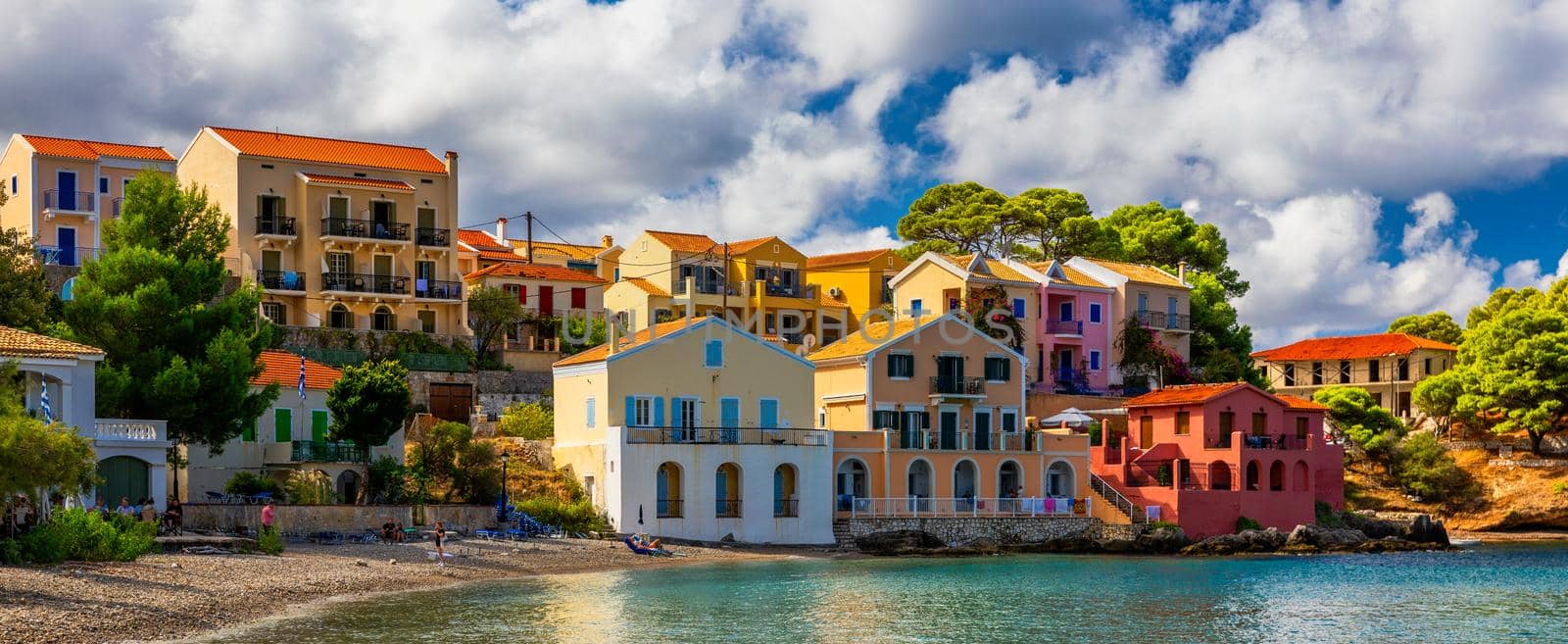 Assos village in Kefalonia, Greece. Turquoise colored bay in Mediterranean sea with beautiful colorful houses in Assos village in Kefalonia, Greece, Ionian island, Cephalonia, Assos village.