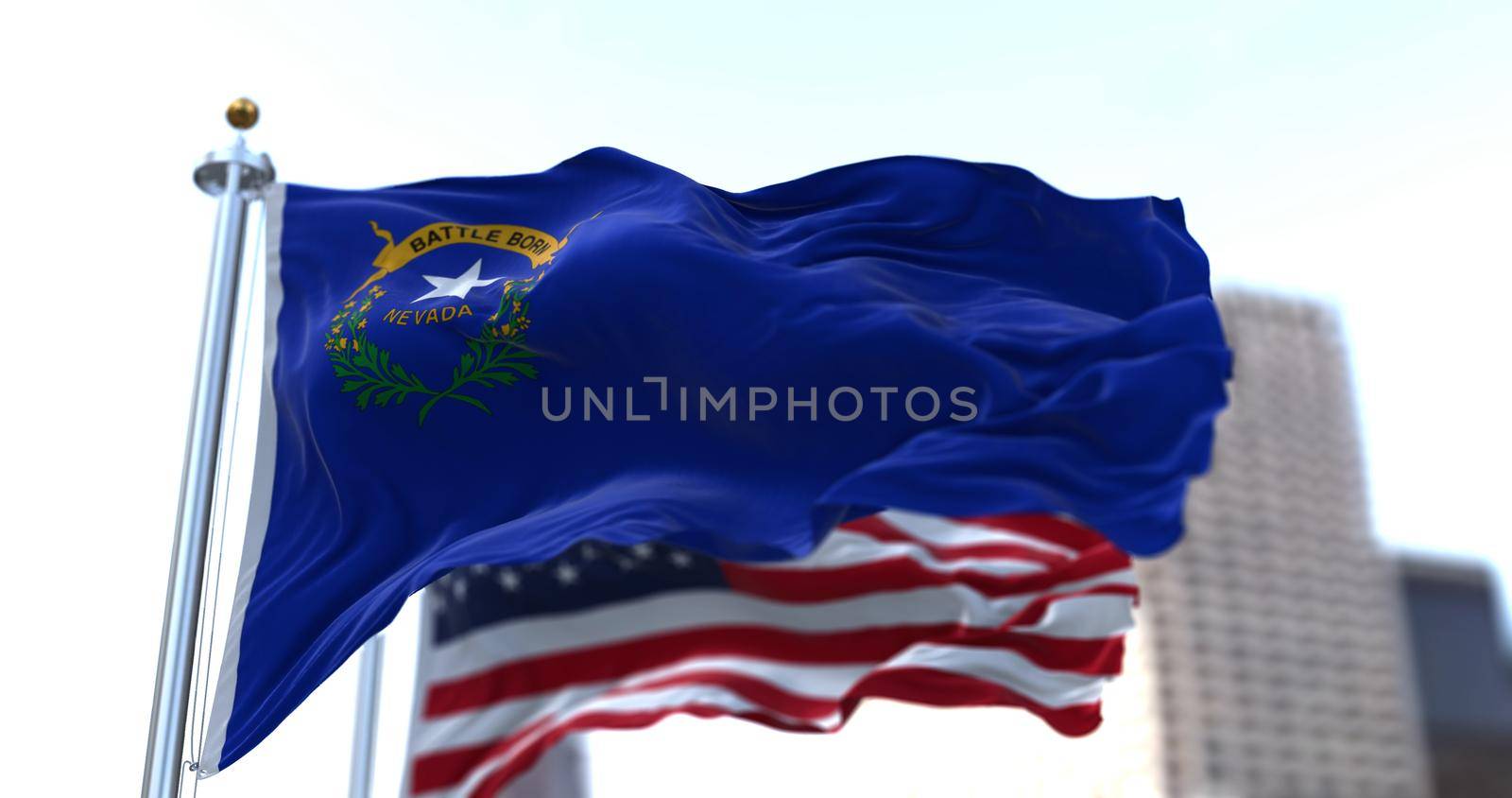 The flags of the Nevada state and United States of America waving in the wind. Democracy and independence. American state.