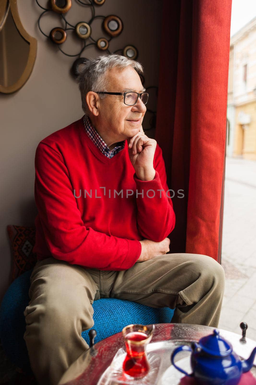 Portrait of pensive senior man in a cafe.