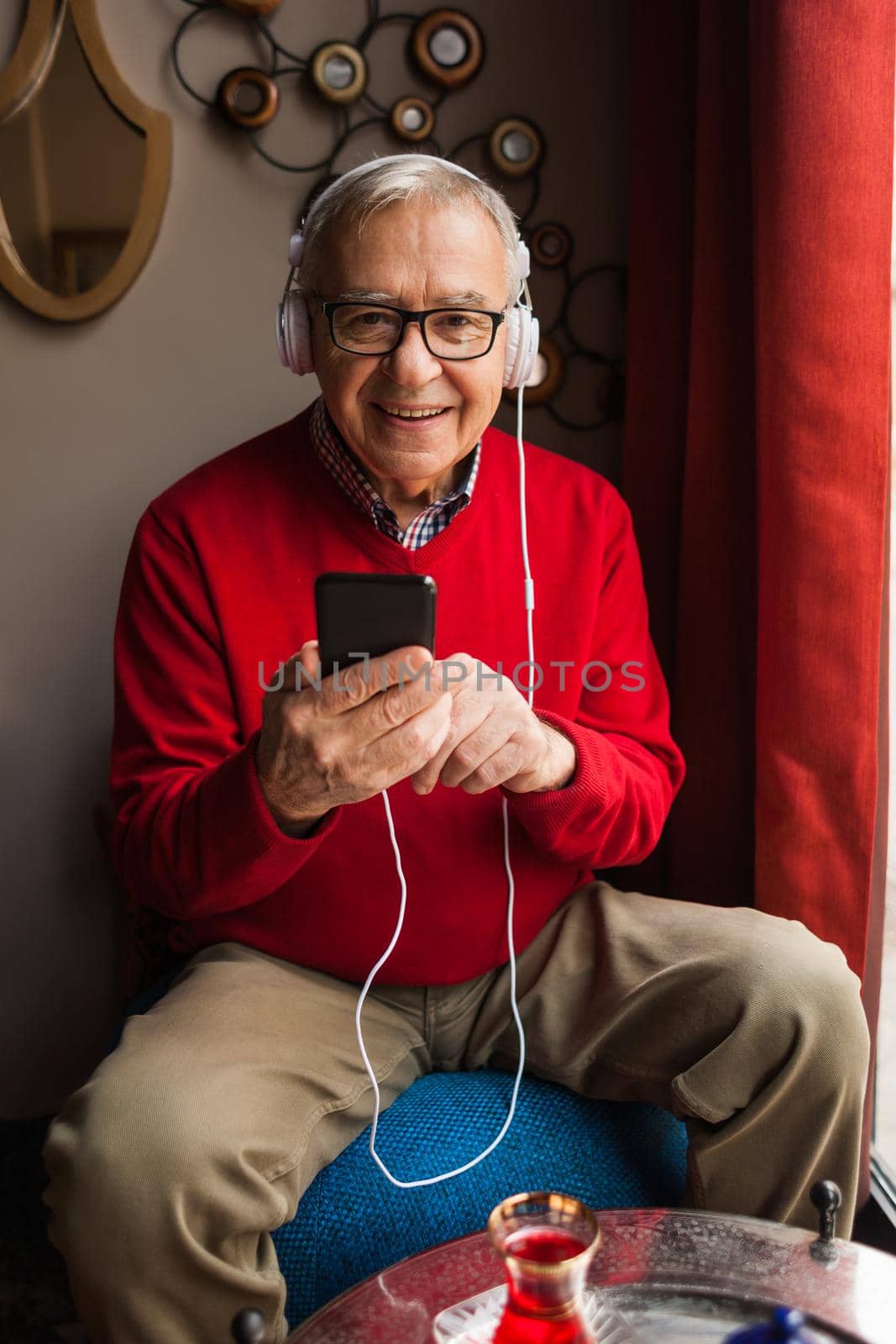 Senior man is sitting in cafe and chatting.