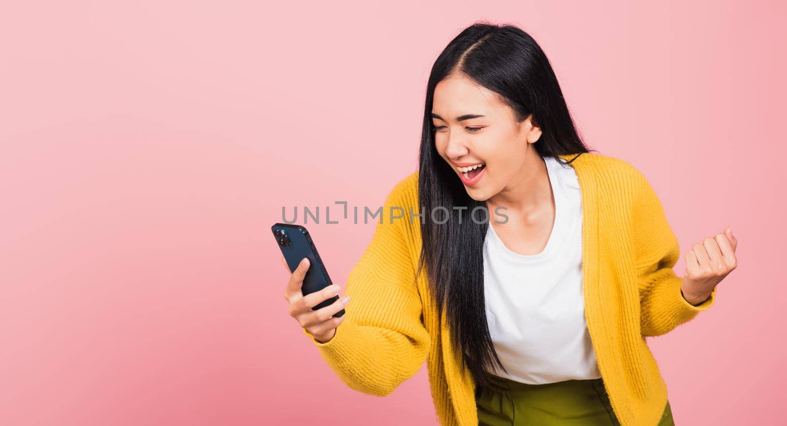 woman teen smiling excited   using mobile phone say yes!  by Sorapop