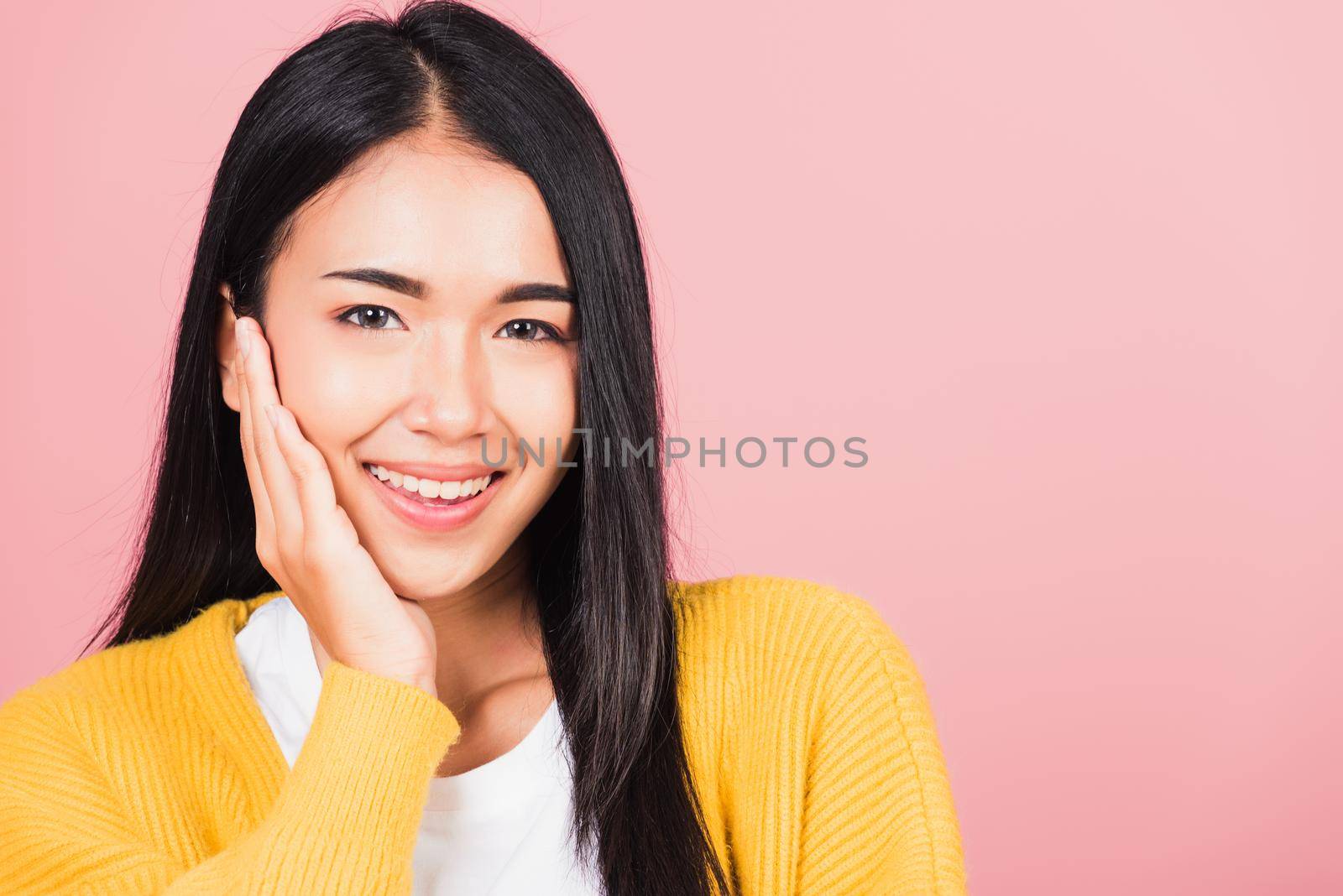 Happy Asian portrait beauty cute young woman teen smiling white teeth surprised excited celebrating gesturing palms on face studio shot isolated on pink background