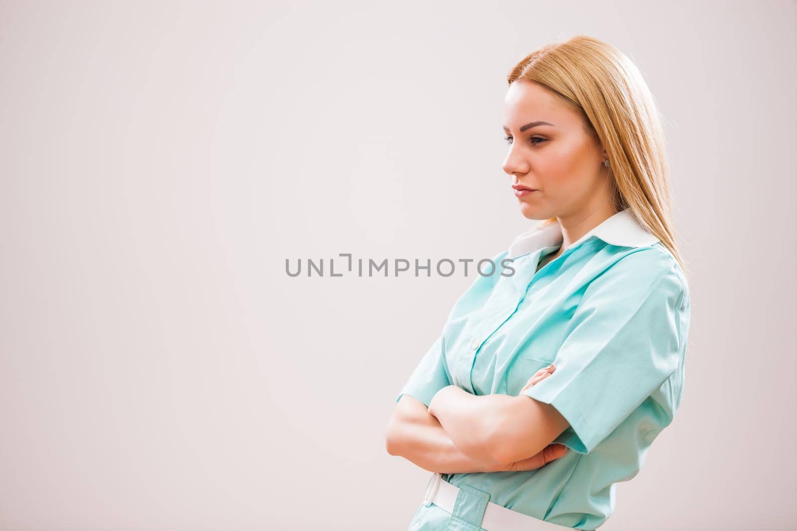 Portrait of young nurse who is worried and pensive.