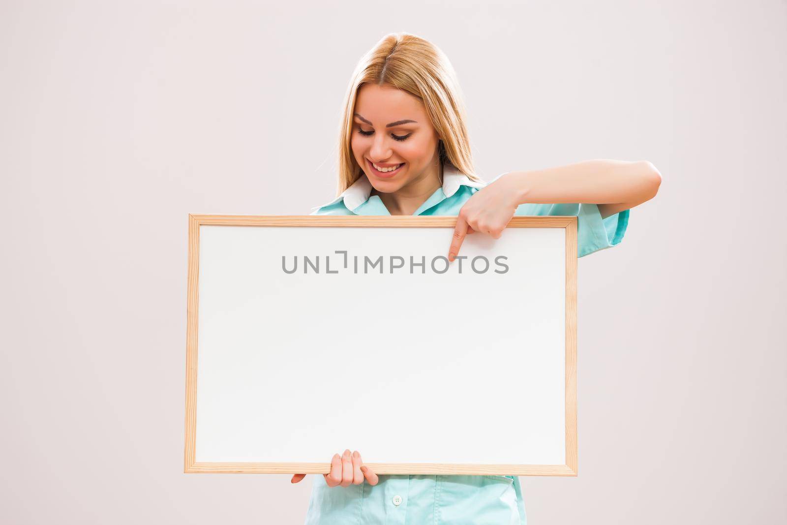Portrait of young nurse who is holding whiteboard.
