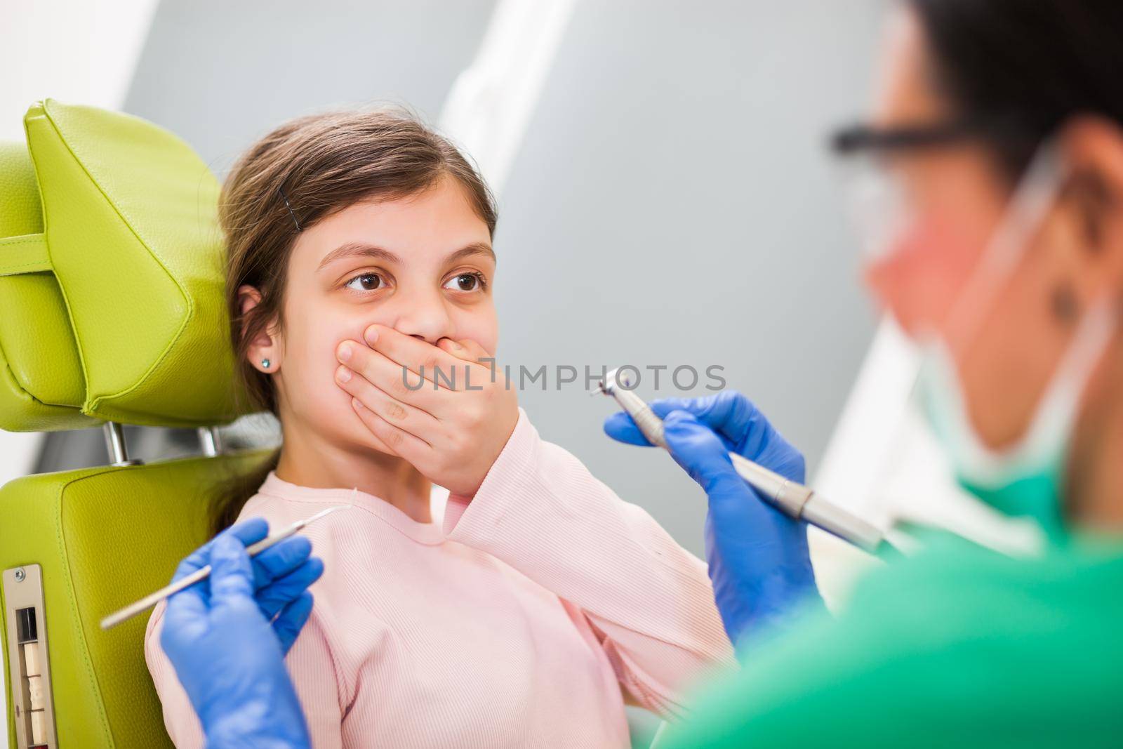 Little girl is afraid of dentist.