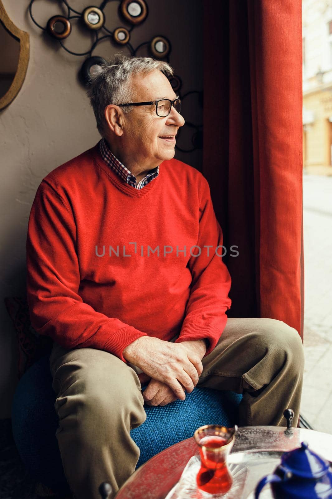 Portrait of happy senior man in a cafe.