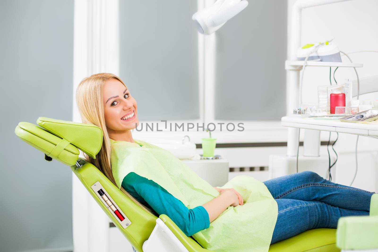 Happy young woman at dentist.