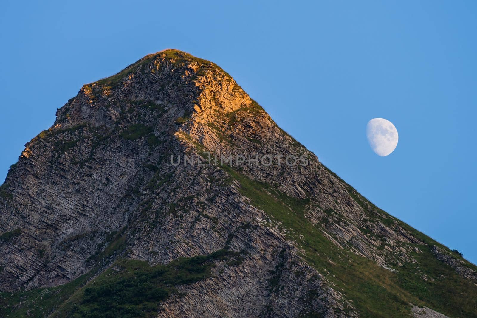 Mountain peak and moon in the late afternoon.