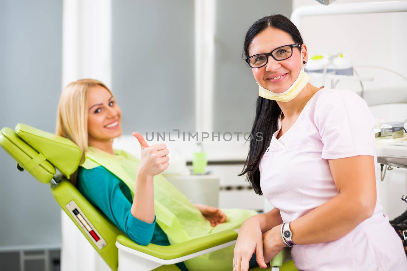 Happy young woman at dentist.