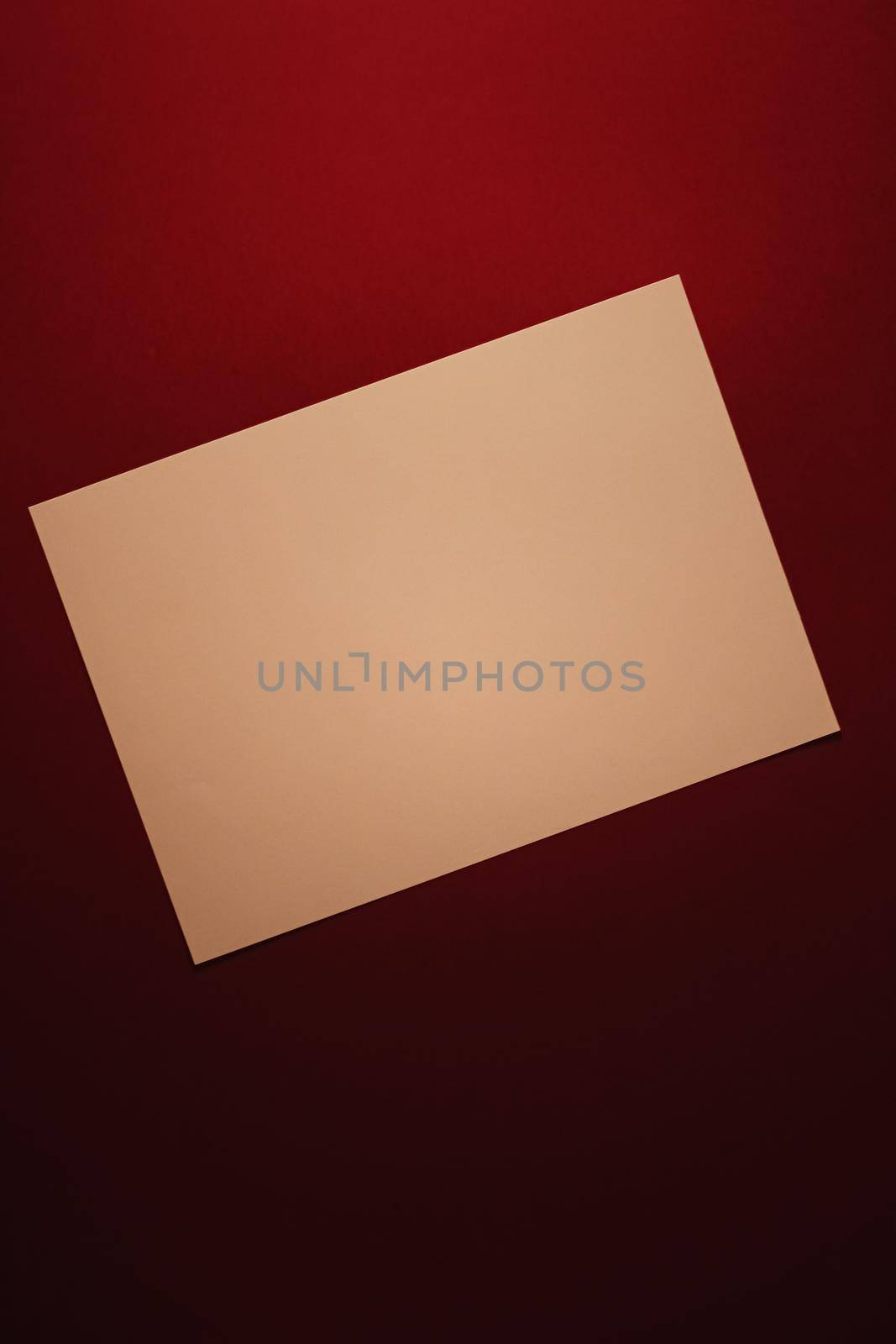 Blank A4 paper, beige on dark red background as office stationery flatlay, luxury branding flat lay and brand identity design for mockup by Anneleven