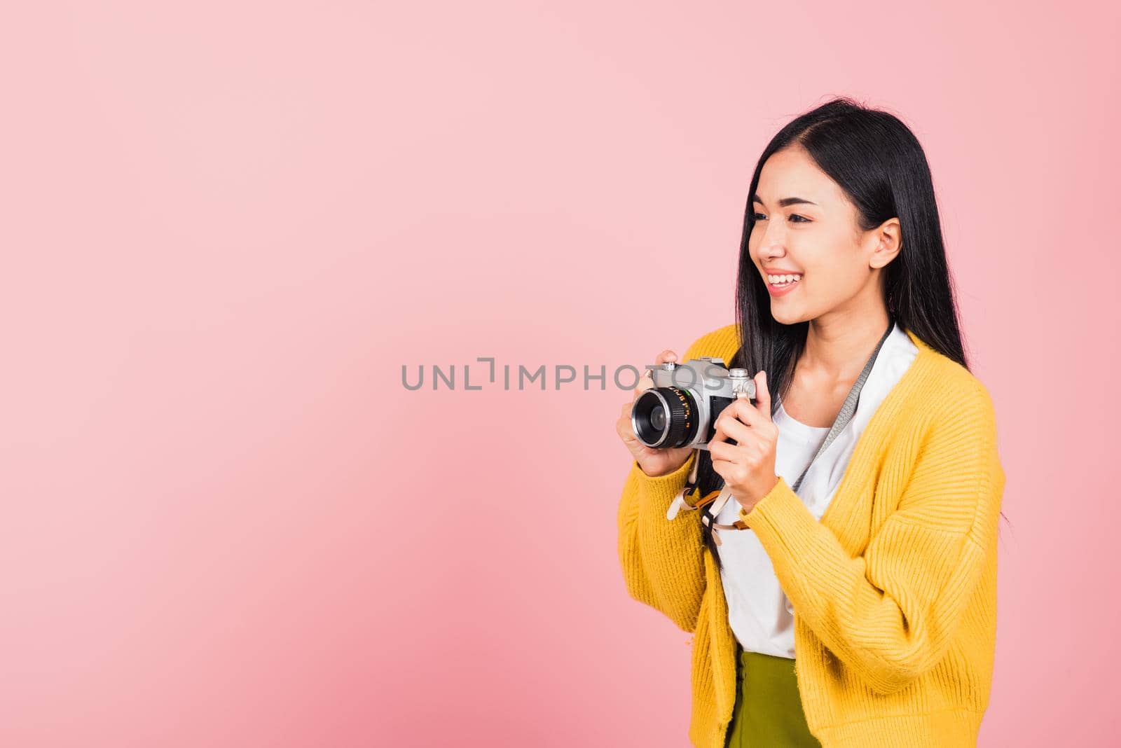 woman excited smiling photographer holding retro vintage photo camera by Sorapop