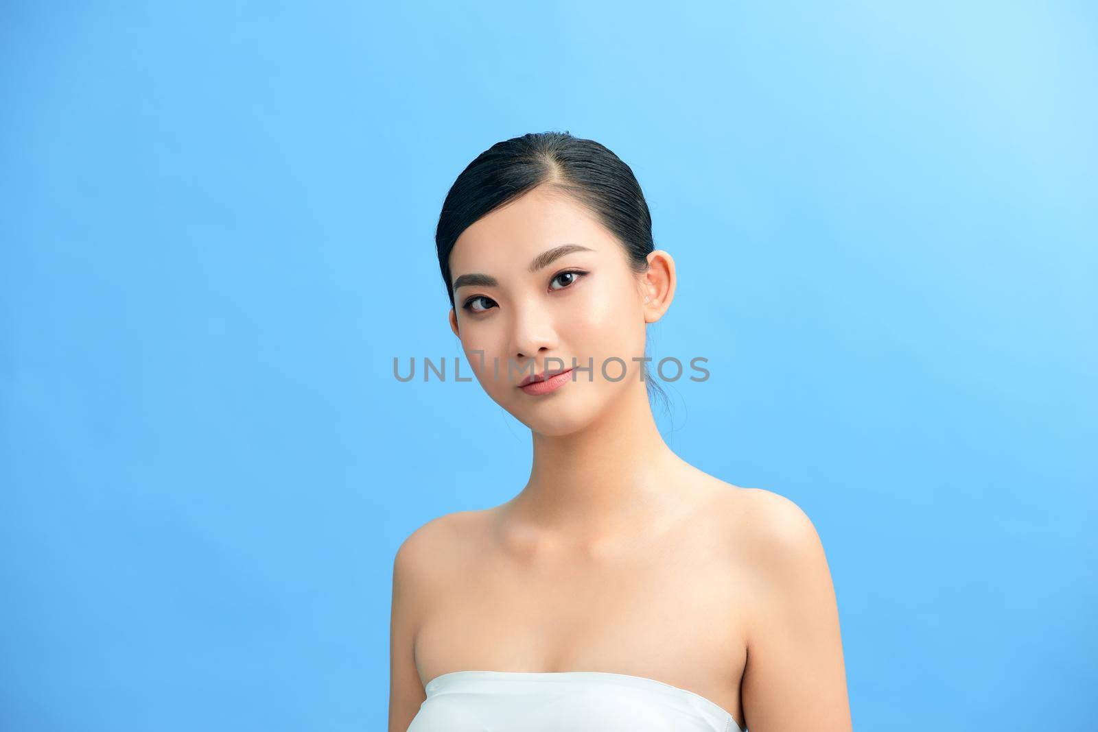 Beautiful woman's face with clean skin - isolated on white by makidotvn